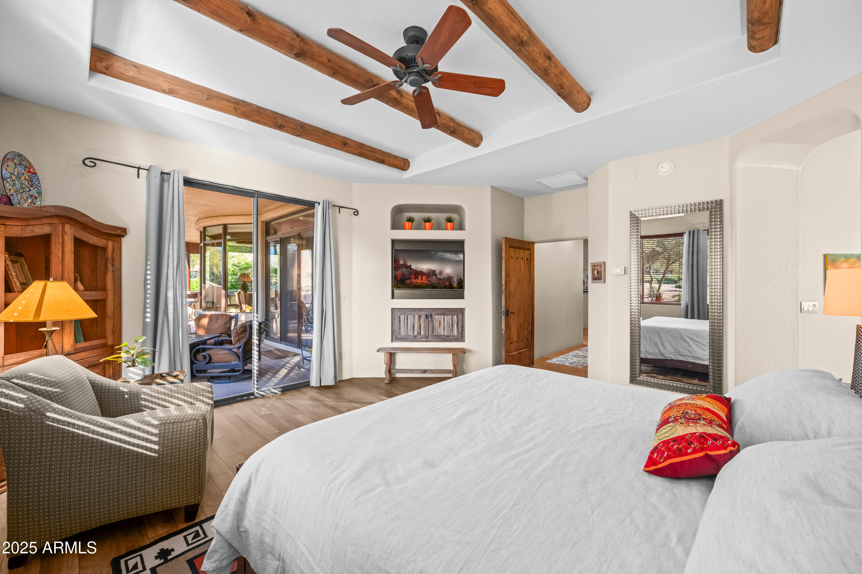 26708 North Aguila Road Rio Verde, AZ 85263 - Photo 20 of 46 a spacious bedroom with a bed and a chandelier