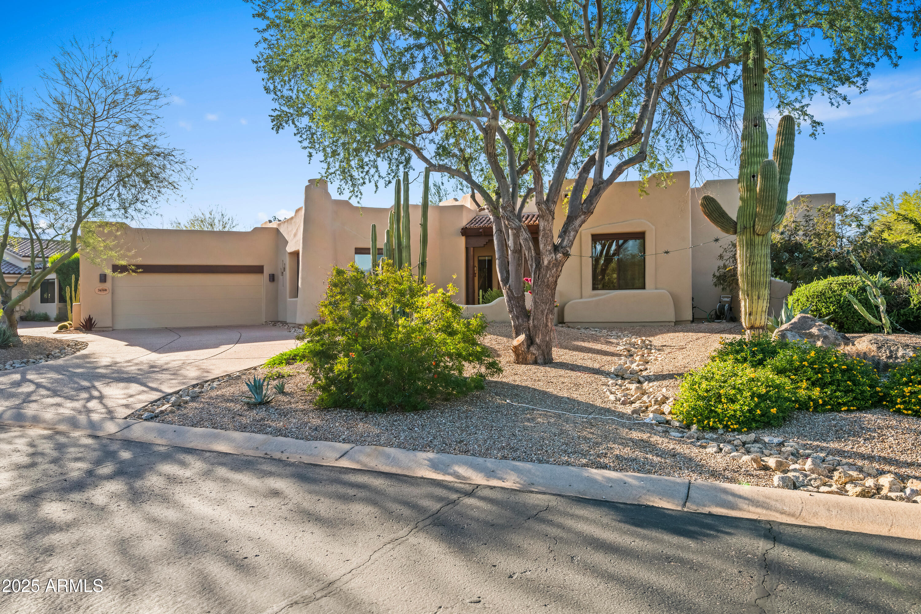 26708 North Aguila Road Rio Verde, AZ 85263 - Photo 2 of 46 a front view of a house with a garden