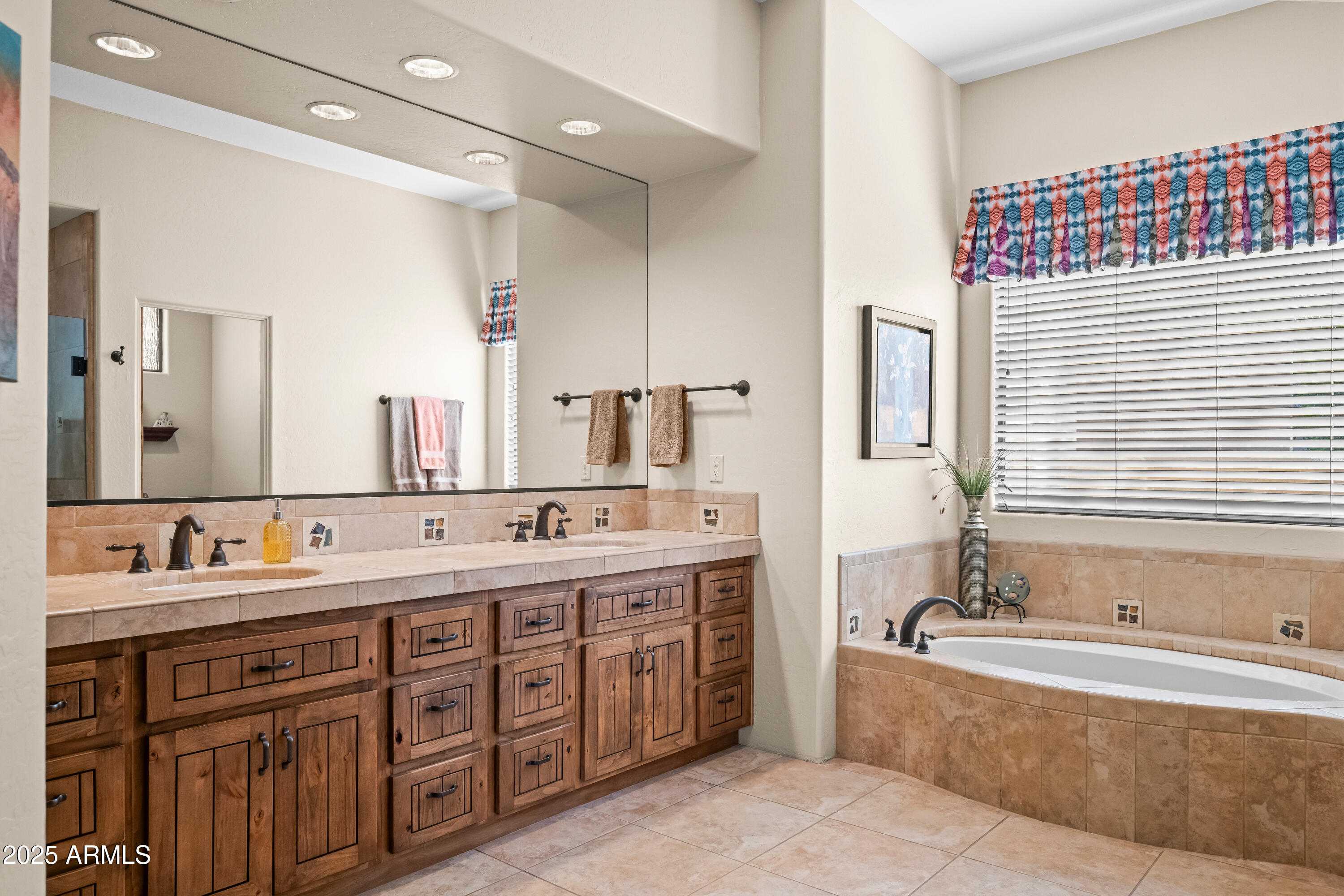 26708 North Aguila Road Rio Verde, AZ 85263 - Photo 23 of 46 a bathroom with a tub double vanity sink and mirror