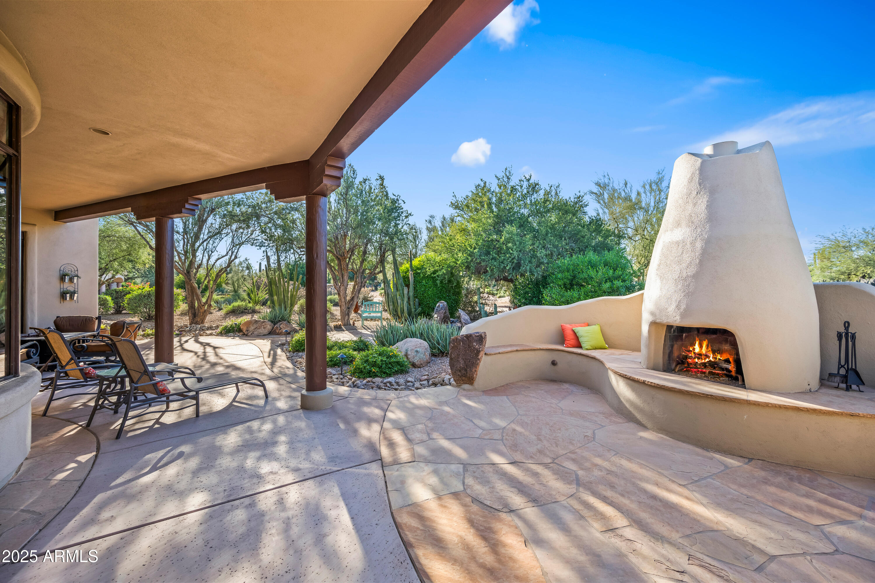 26708 North Aguila Road Rio Verde, AZ 85263 - Photo 36 of 46 a backyard of a house with table and chairs