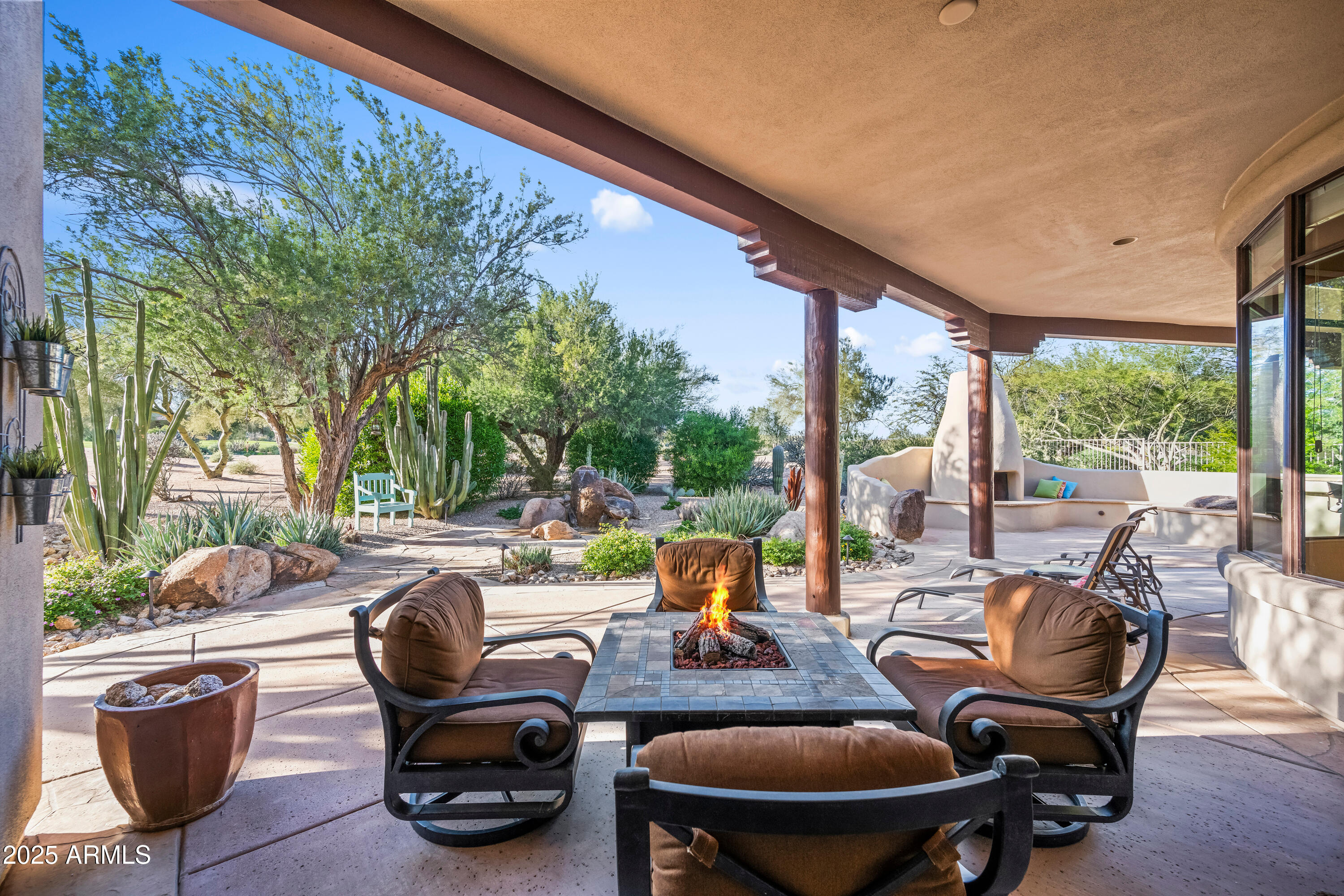 26708 North Aguila Road Rio Verde, AZ 85263 - Photo 38 of 46 a view of a patio with lawn chairs and a potted plant