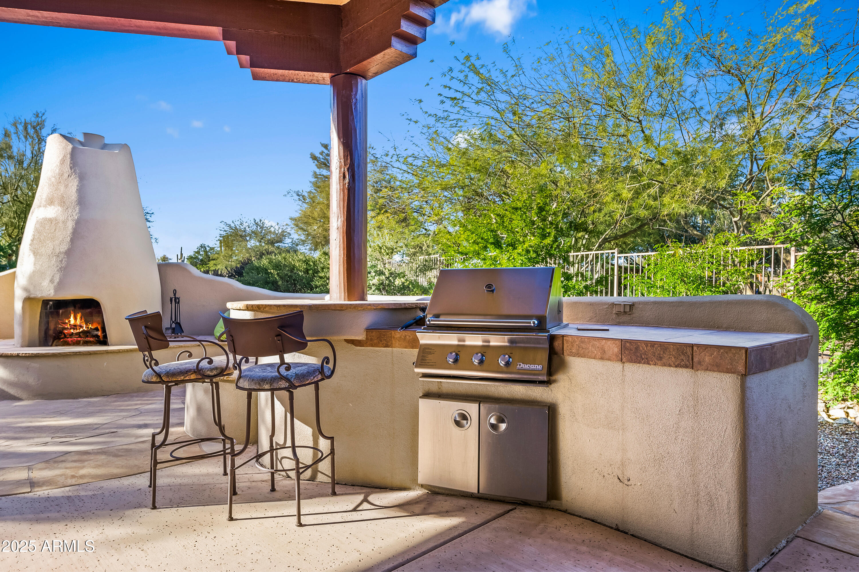 26708 North Aguila Road Rio Verde, AZ 85263 - Photo 40 of 46 a view of a patio with table and chairs with wooden floor and fence