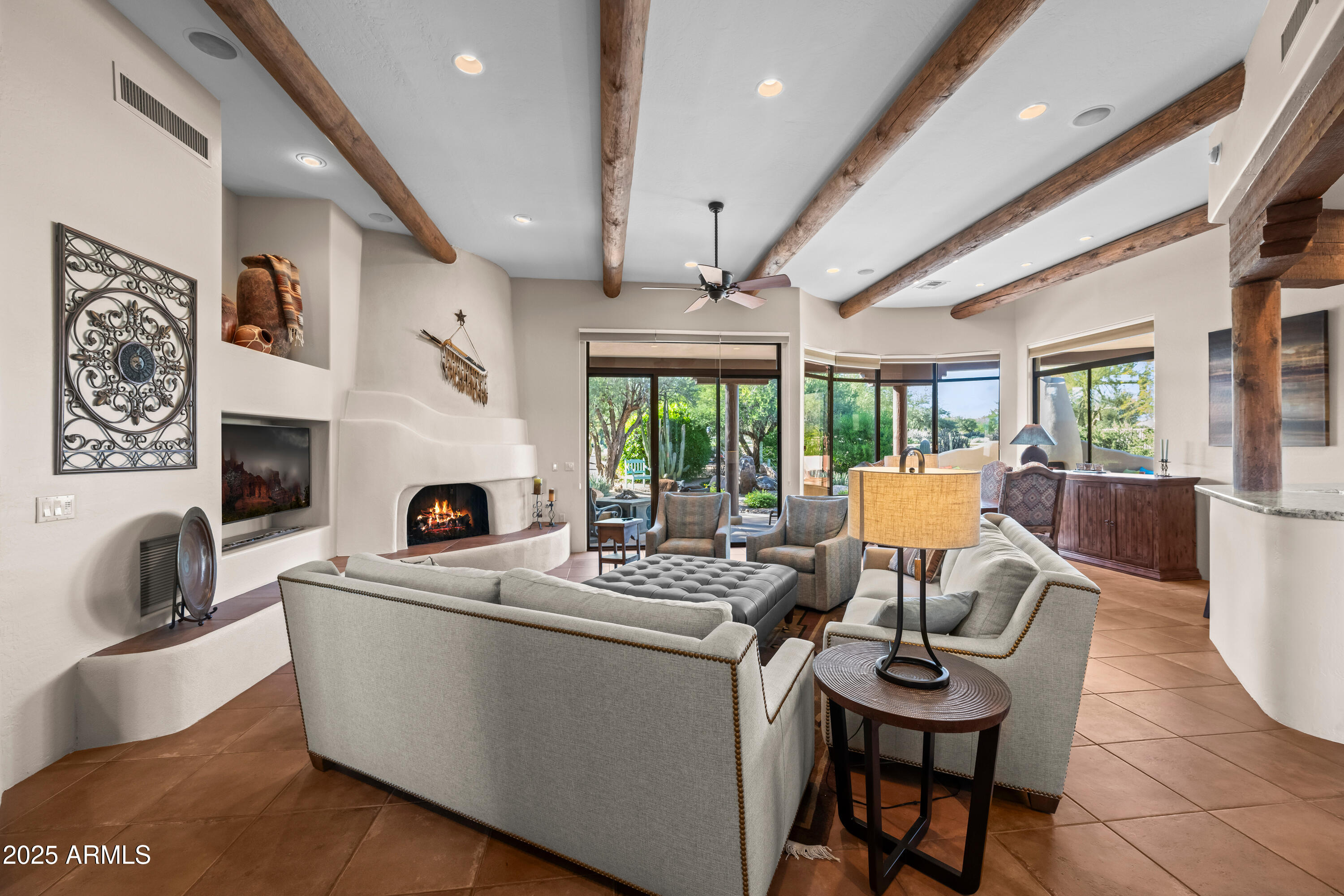 26708 North Aguila Road Rio Verde, AZ 85263 - Photo 8 of 46 a living room with furniture a fireplace and a table