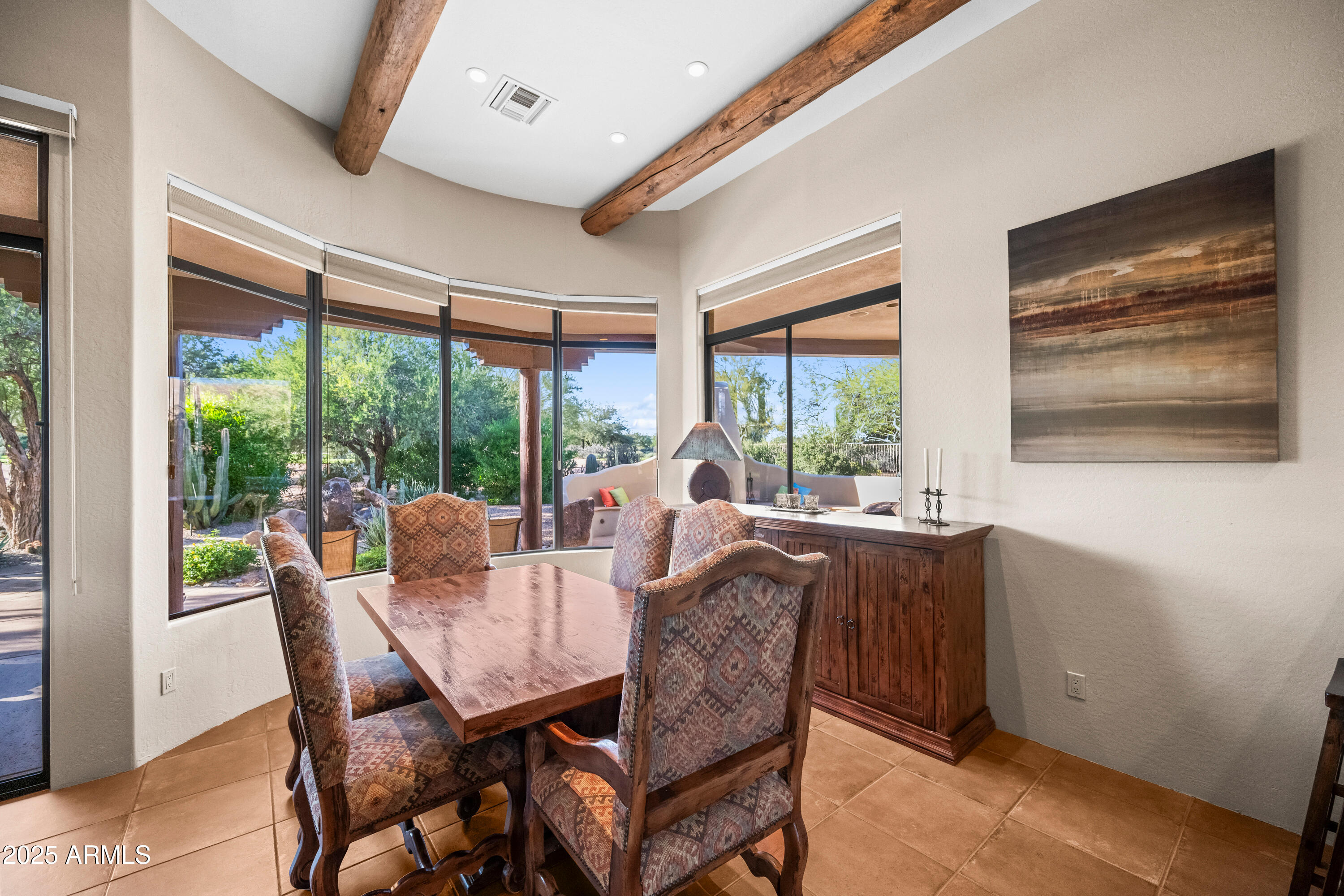 26708 North Aguila Road Rio Verde, AZ 85263 - Photo 10 of 46 a dining room with furniture large windows and wooden floor