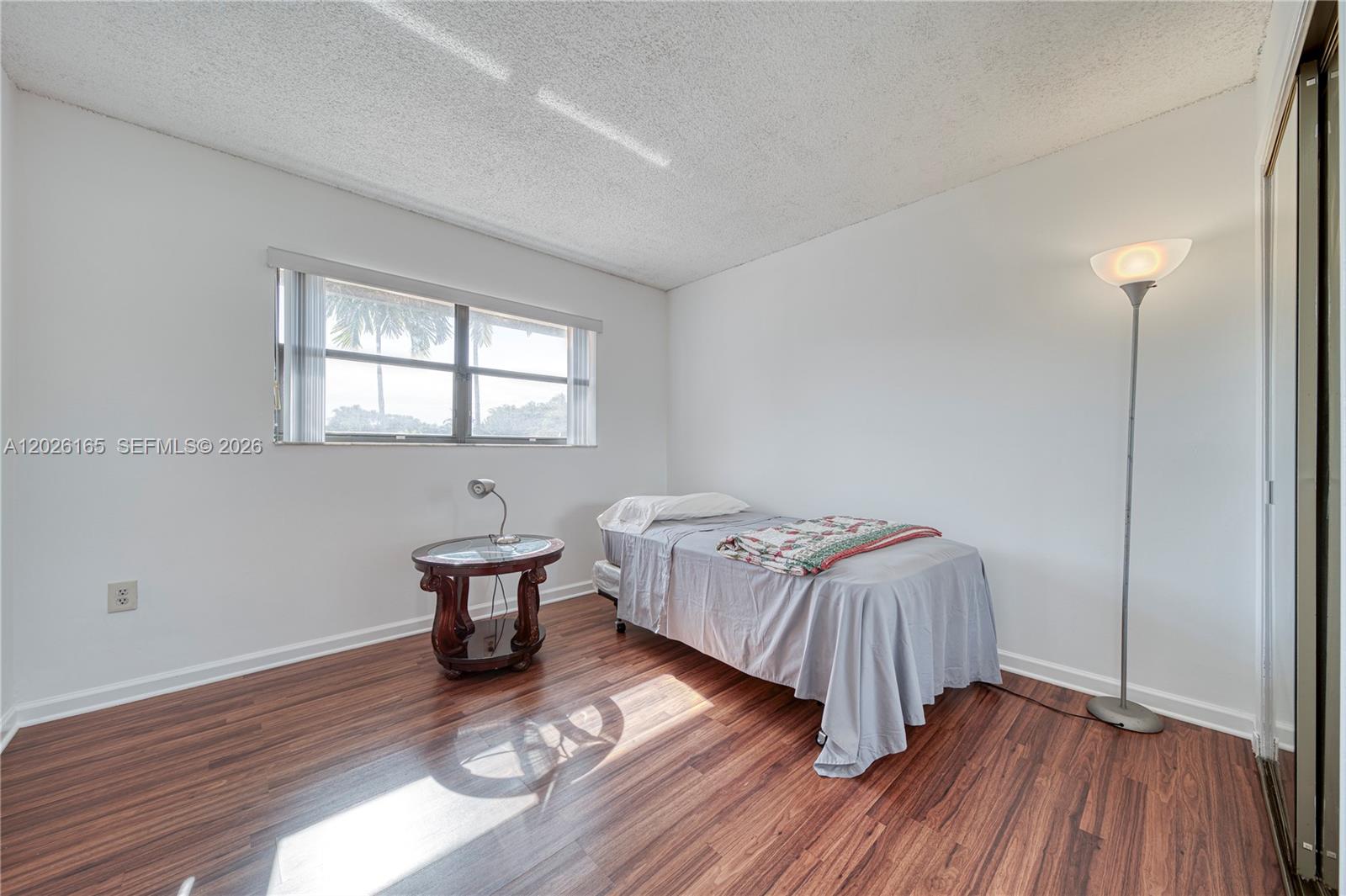 13337 Southwest 64th Lane Miami, FL 33183 - Photo 27 of 36 a bedroom with a bed and wooden floor