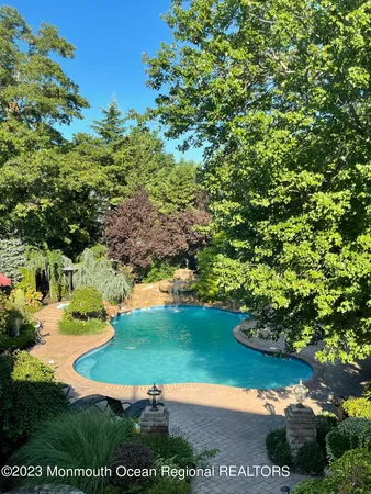a view of a golf club with a house in the background