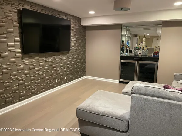 a living room with couches and a flat screen tv