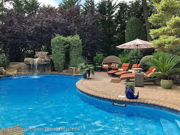 a backyard of a house with table and chairs
