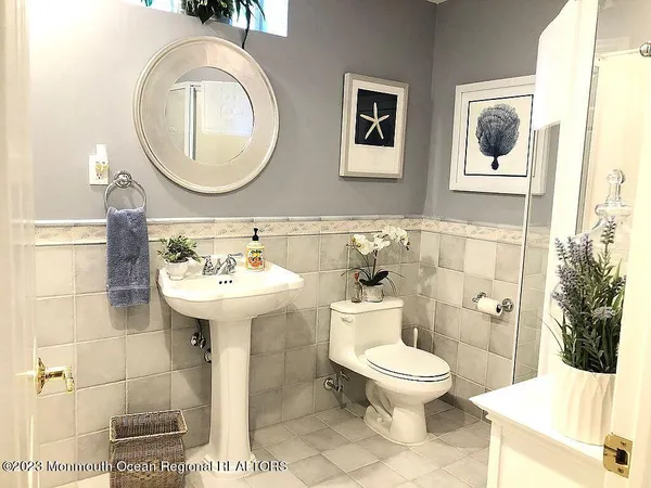 a bathroom with a toilet sink and mirror