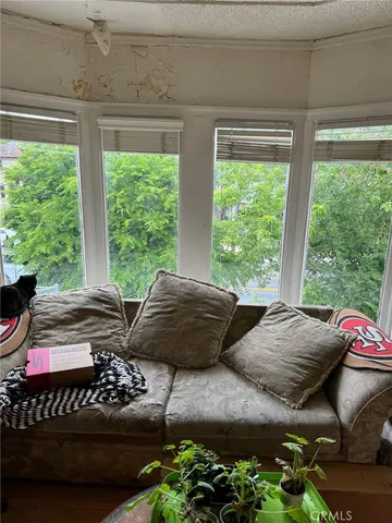 a living room with furniture and a floor to ceiling window