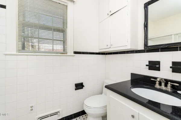 an aerial view of residential house with outdoor space and trees all around