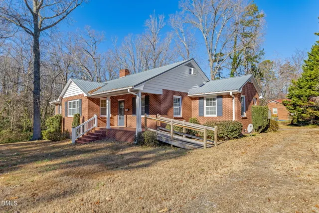 a view of a dining room with furniture and window