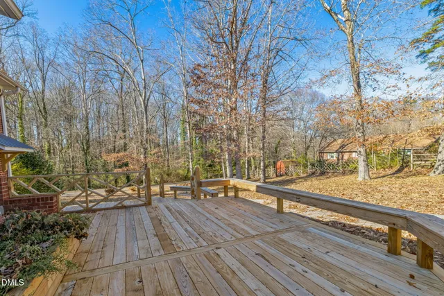 a bedroom with a large bed chandelier and a window