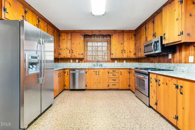 a view of a roof deck with table and chairs with wooden floor and fence