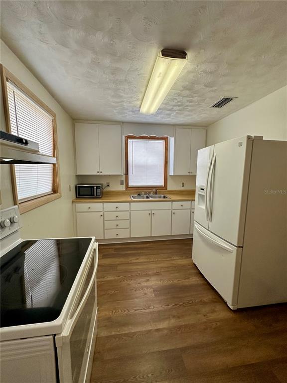 520 Southwest 5th Avenue Lake Butler, FL 32054 - Photo 2 of 54 a kitchen with stainless steel appliances granite countertop a refrigerator a sink dishwasher a stove with wooden cabinets and floor