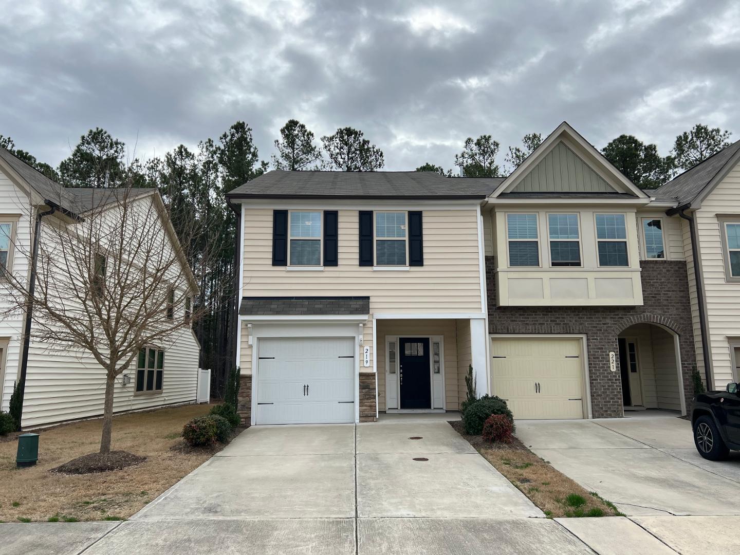 219 Cross Blossom Road Durham, NC 27703 - Photo 1 of 35 a front view of a house with a yard and garage