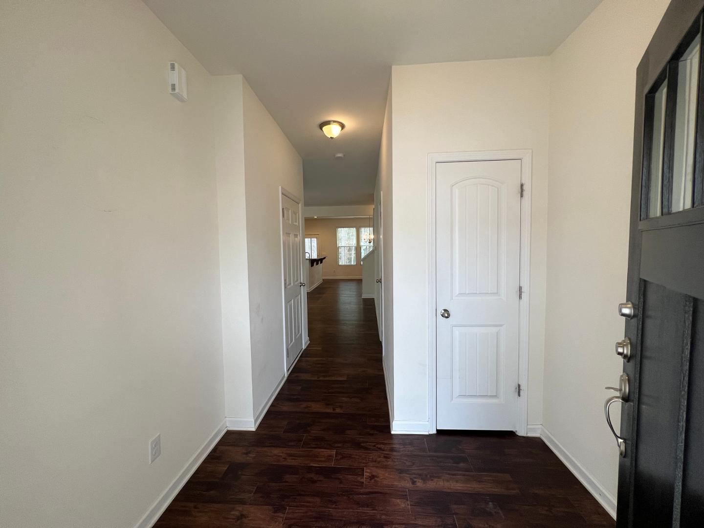 219 Cross Blossom Road Durham, NC 27703 - Photo 15 of 35 a view of a hallway with wooden floor and staircase