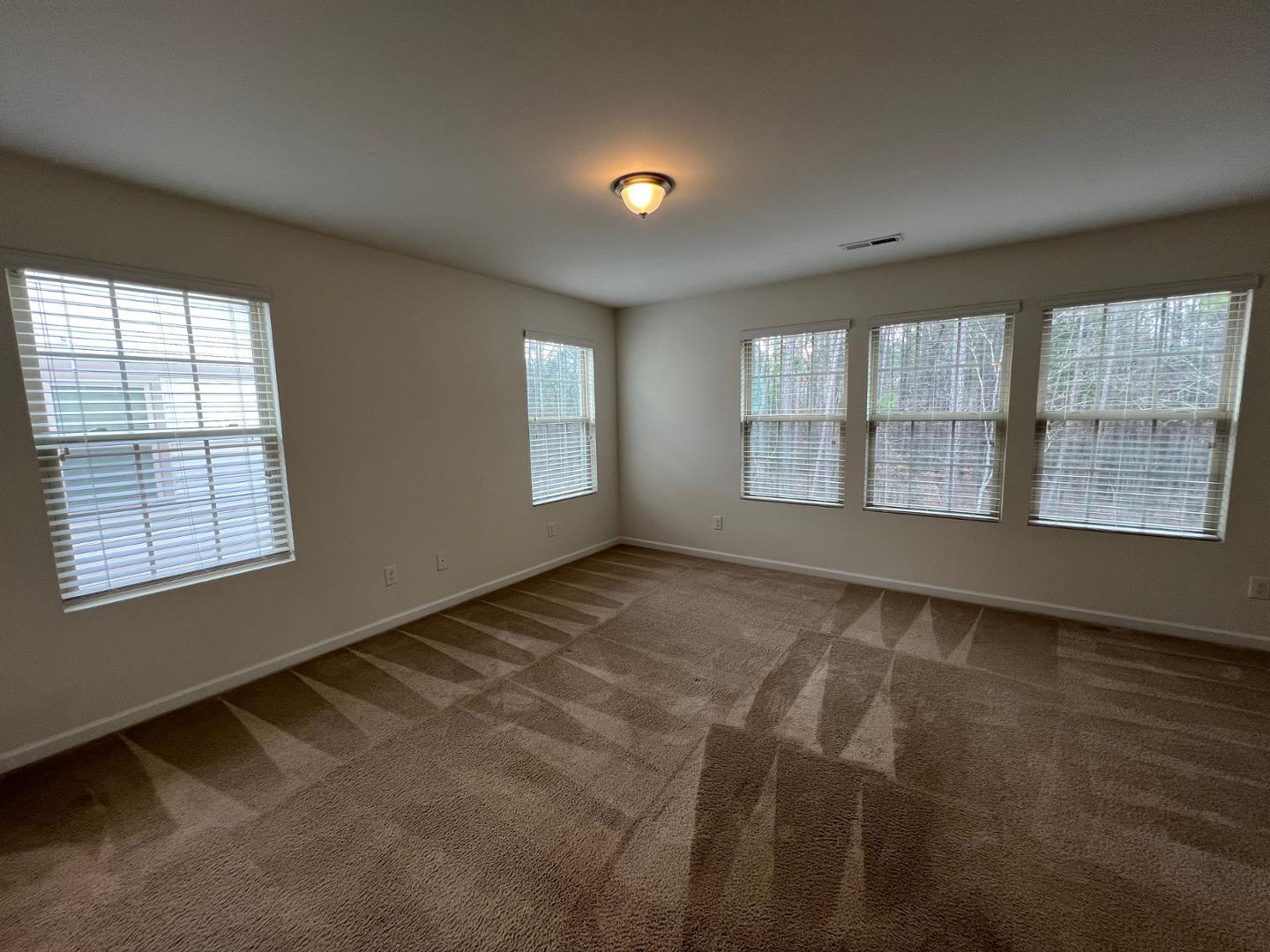 219 Cross Blossom Road Durham, NC 27703 - Photo 16 of 35 a view of an empty room with a window