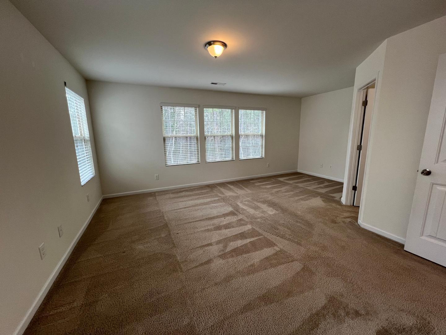 219 Cross Blossom Road Durham, NC 27703 - Photo 17 of 35 a view of an empty room with a window