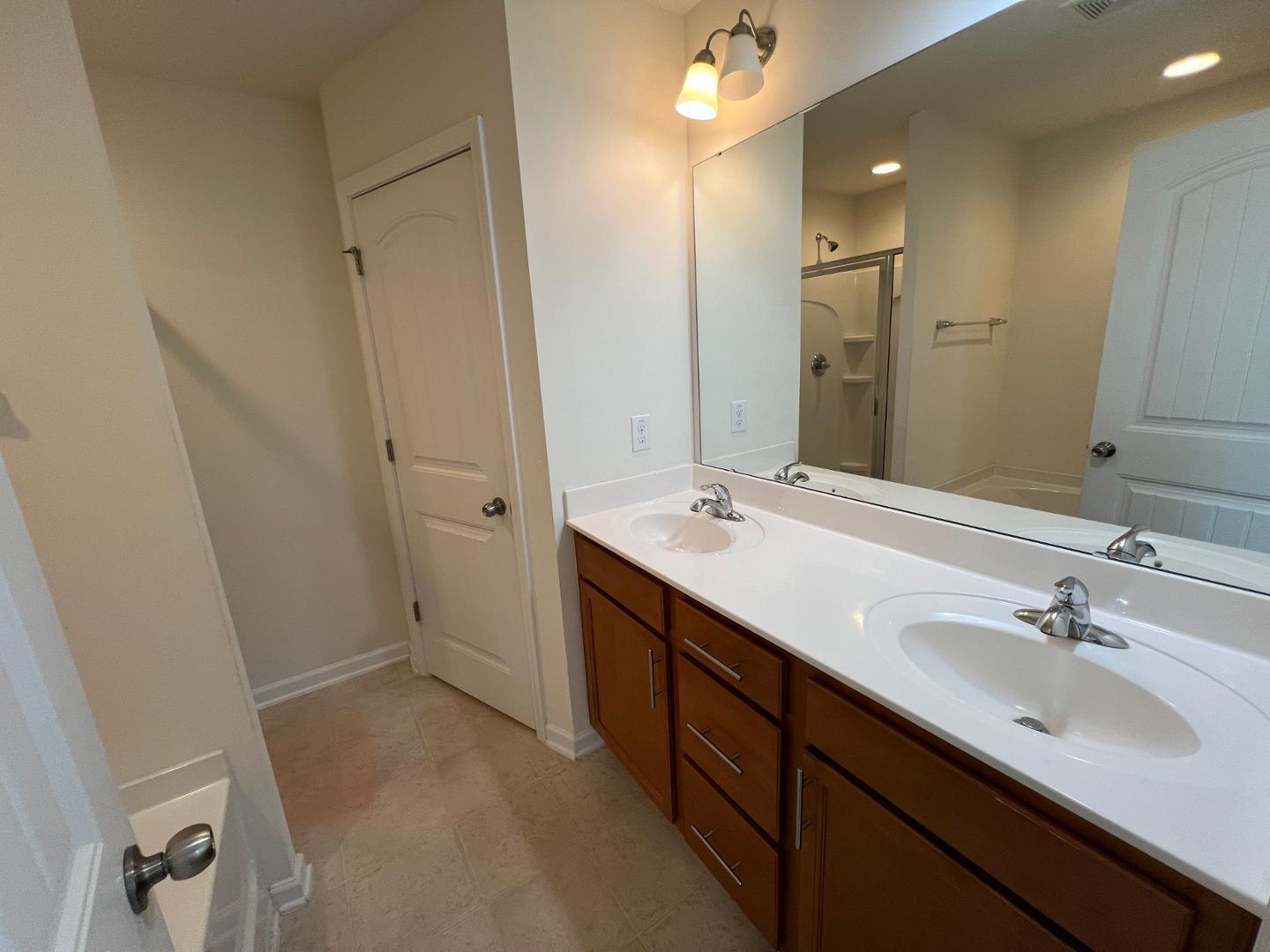 219 Cross Blossom Road Durham, NC 27703 - Photo 20 of 35 a bathroom with a double vanity sink a and mirror