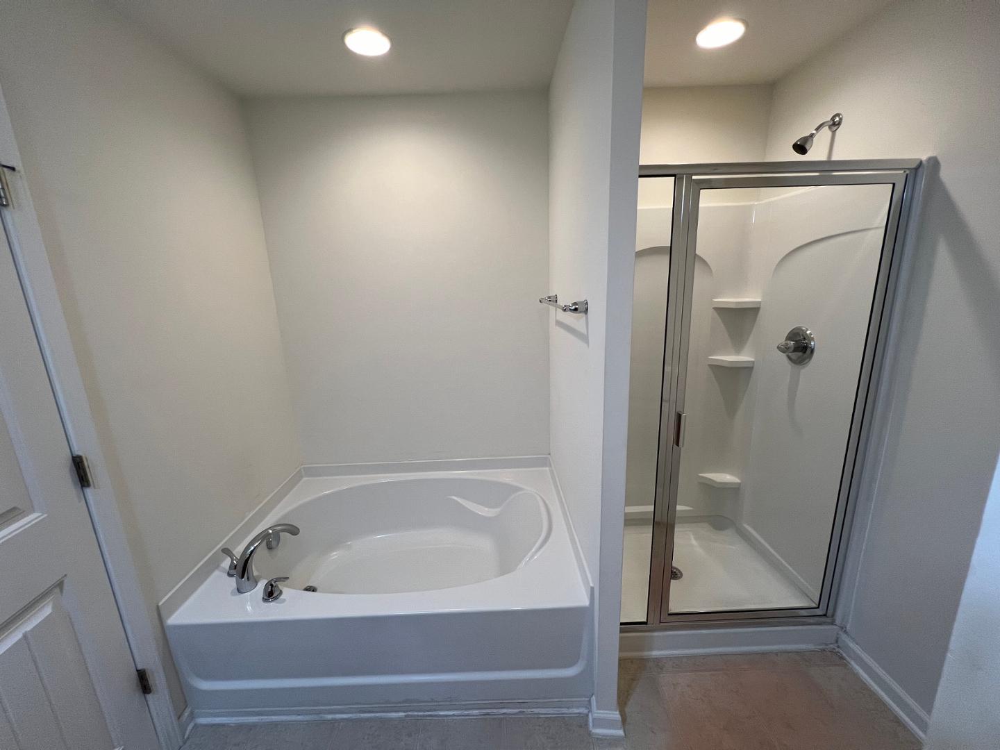 219 Cross Blossom Road Durham, NC 27703 - Photo 21 of 35 a bathroom with a bathtub and shower