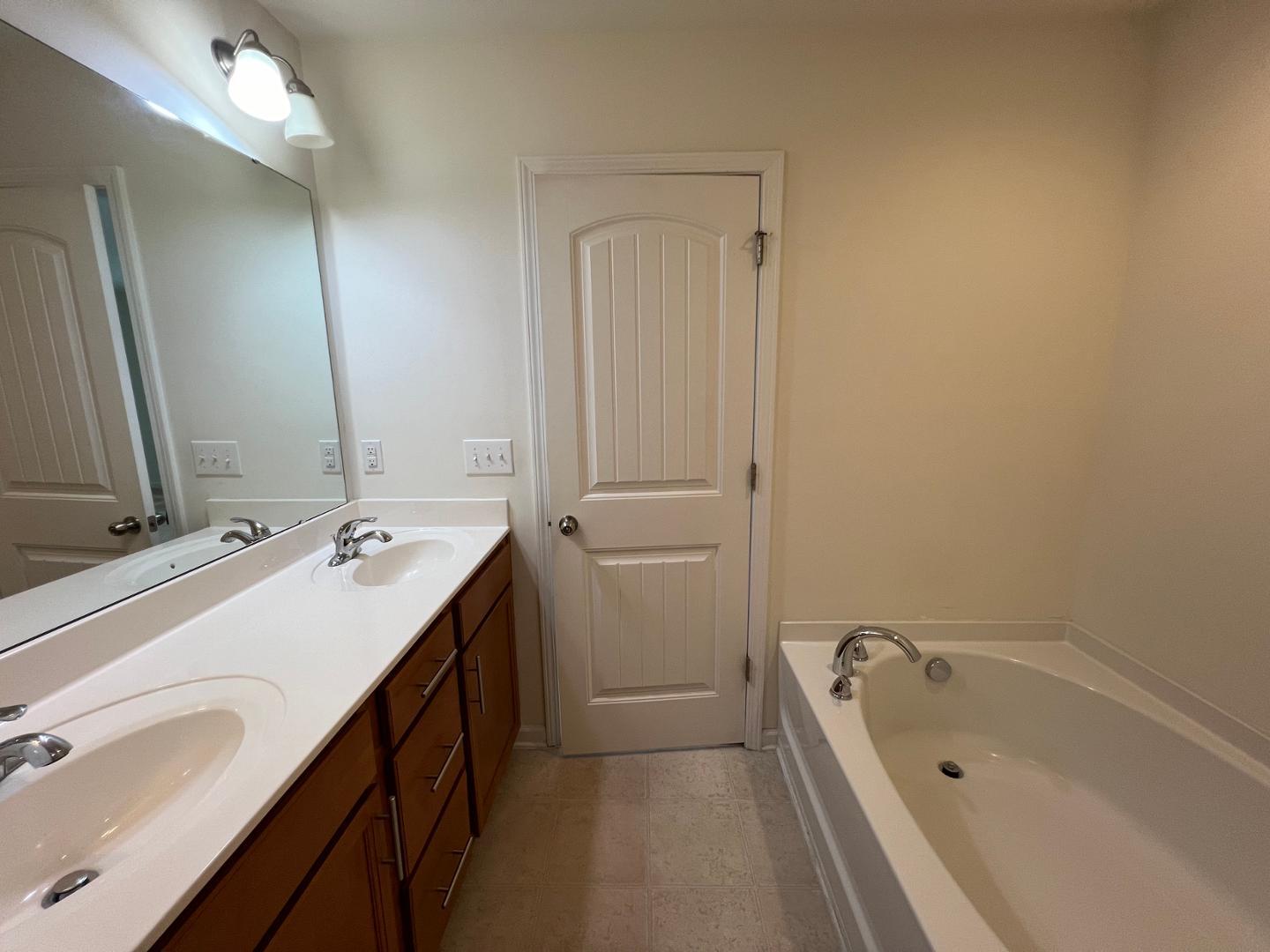 219 Cross Blossom Road Durham, NC 27703 - Photo 22 of 35 a bathroom with a tub sink and mirror