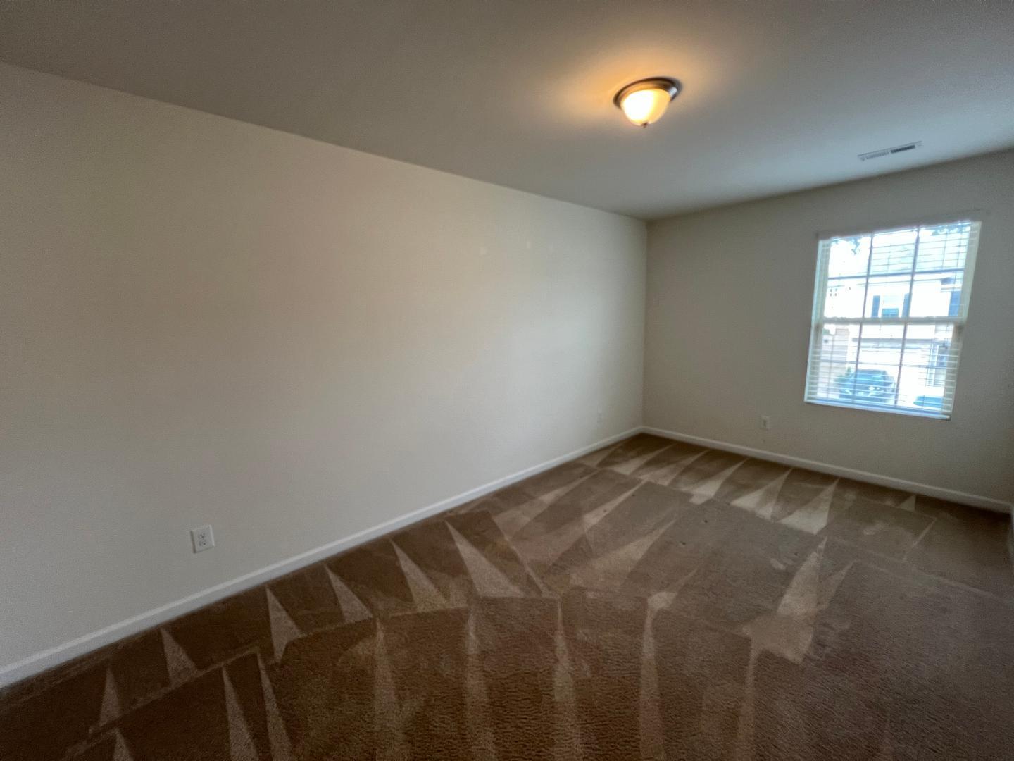 219 Cross Blossom Road Durham, NC 27703 - Photo 23 of 35 a view of an empty room and window