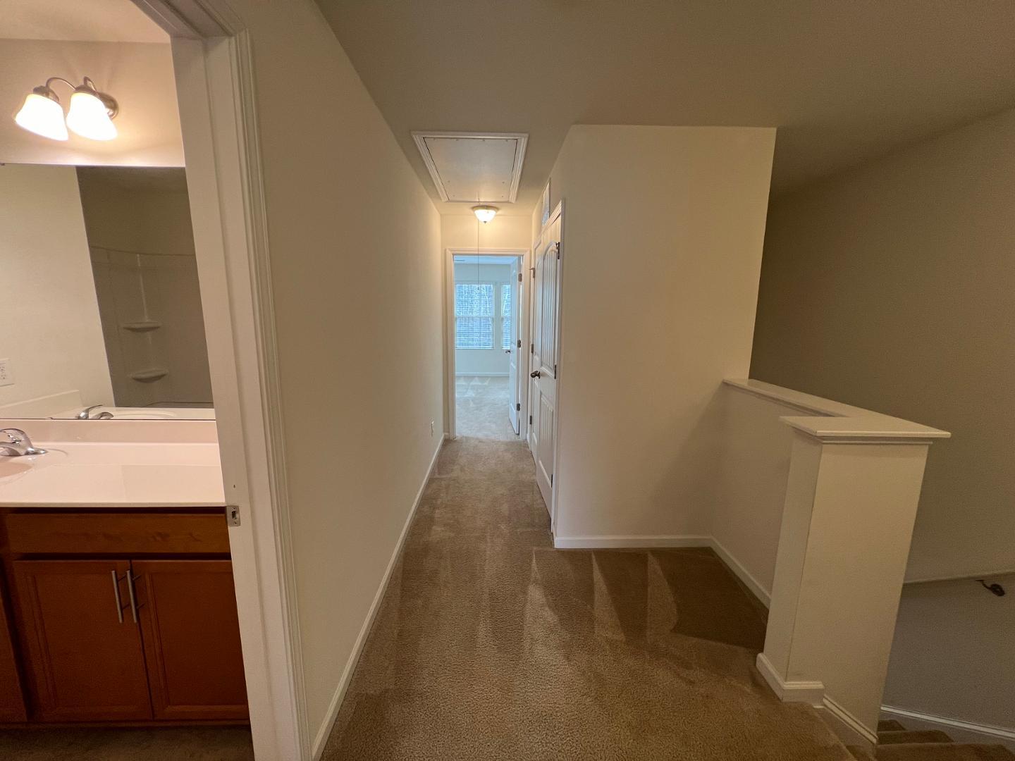 219 Cross Blossom Road Durham, NC 27703 - Photo 29 of 35 a view of hallway with a sink and a mirror
