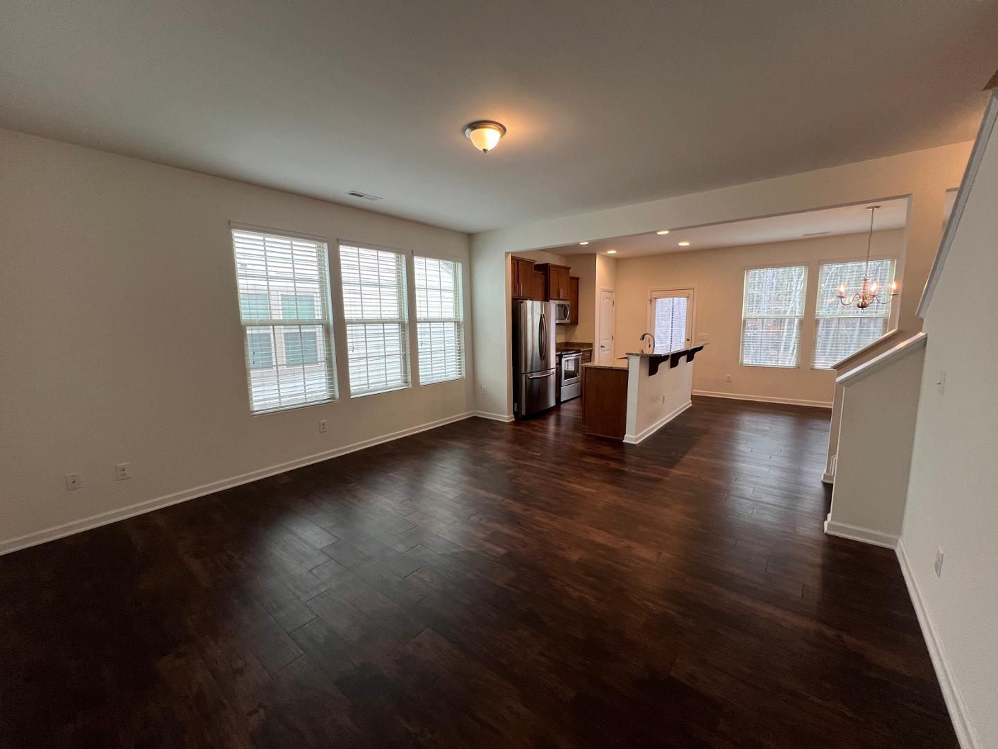 219 Cross Blossom Road Durham, NC 27703 - Photo 3 of 35 a view of an empty room with wooden floor and a window