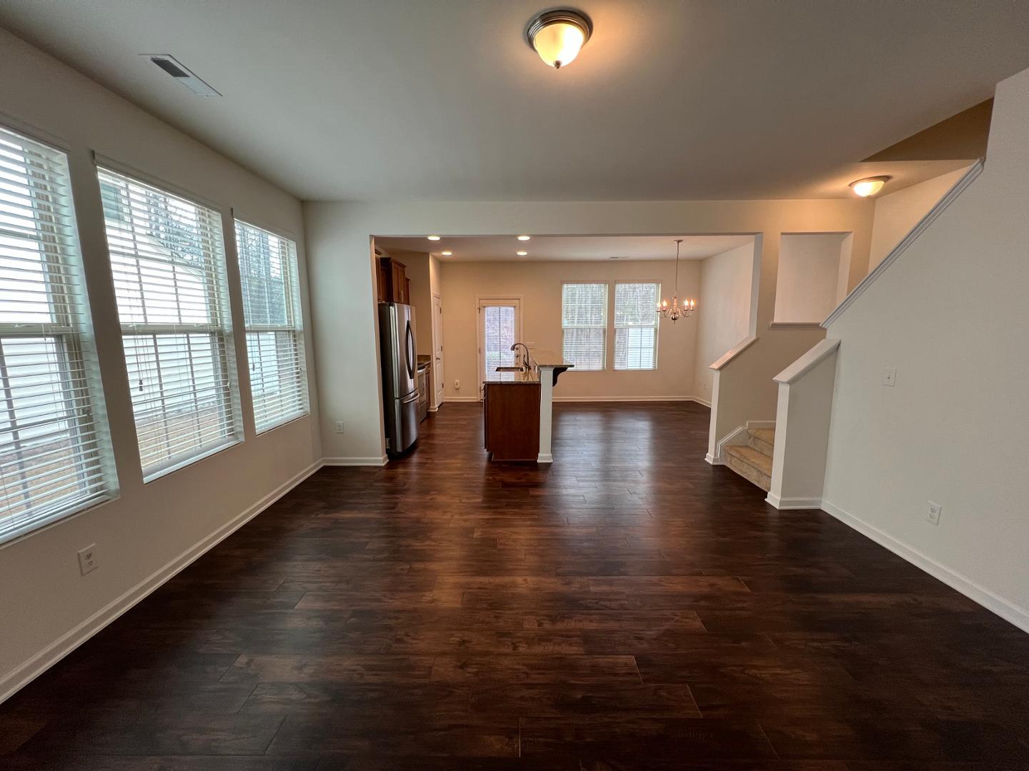 219 Cross Blossom Road Durham, NC 27703 - Photo 5 of 35 an empty room with wooden floor and windows