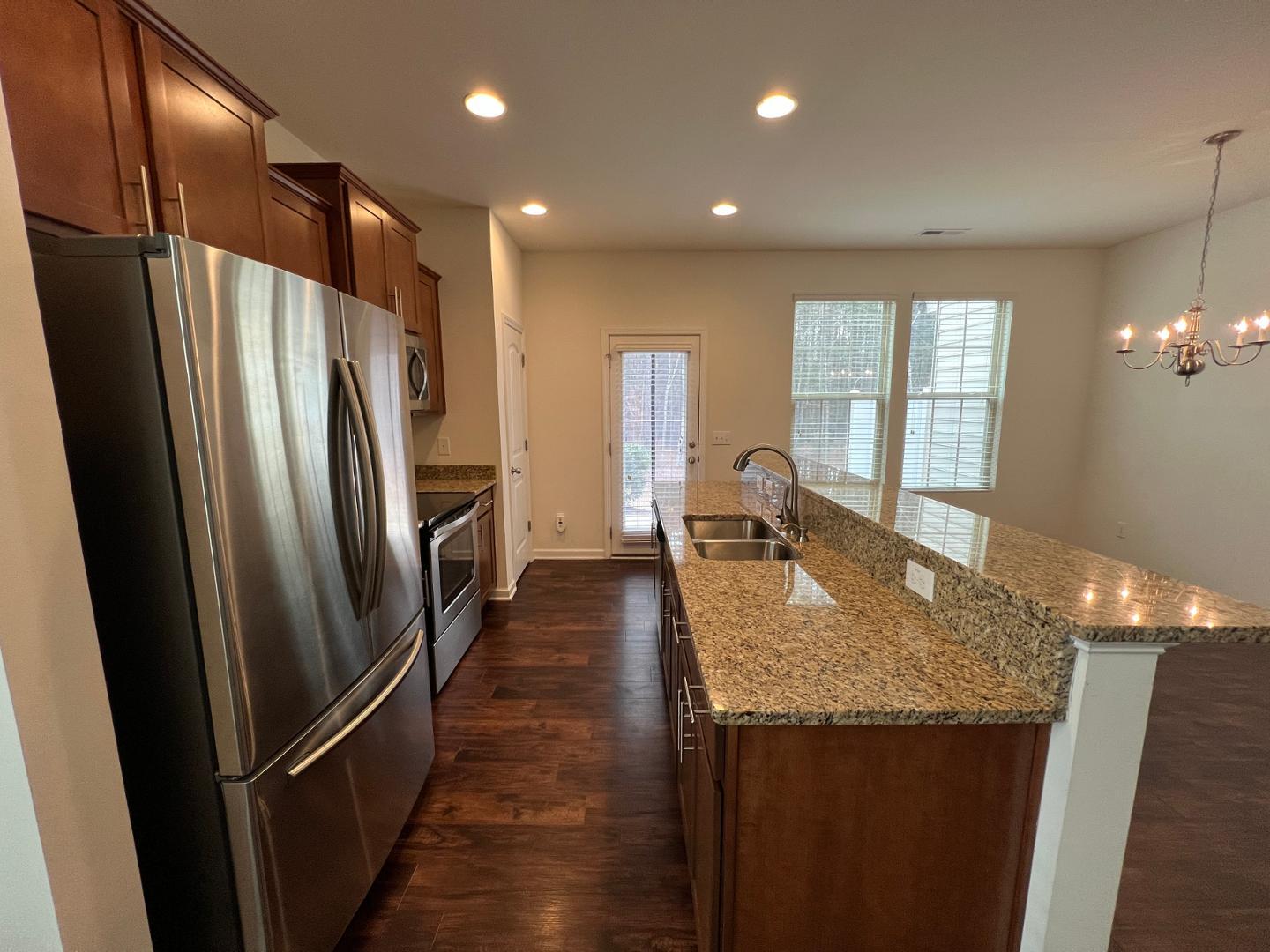 219 Cross Blossom Road Durham, NC 27703 - Photo 6 of 35 a kitchen with granite countertop a refrigerator and a sink