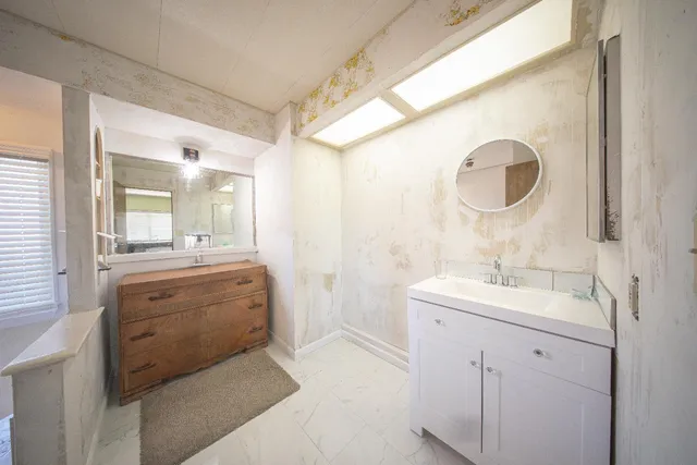 a bathroom with a sink and a mirror