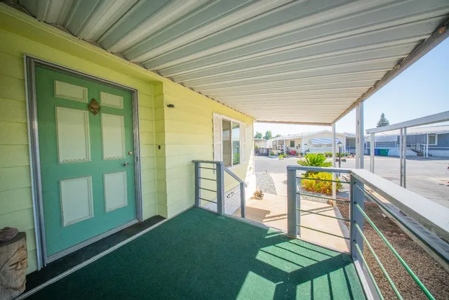 a view of a porch with furniture and a gate