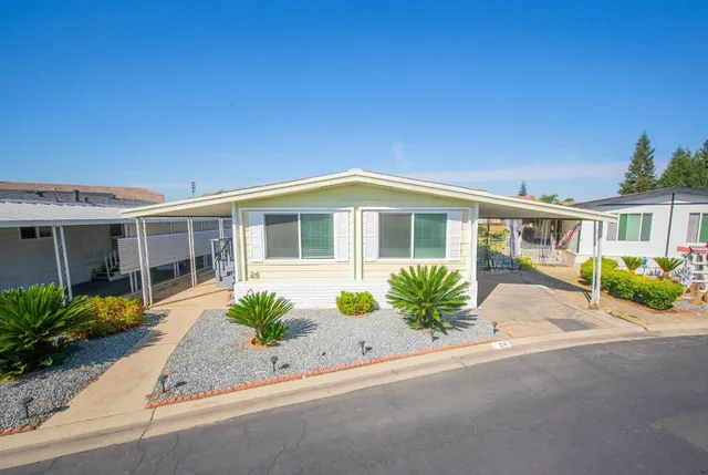 a front view of house and yard with green space