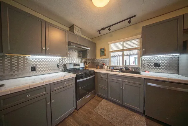 a kitchen with a sink cabinets and window