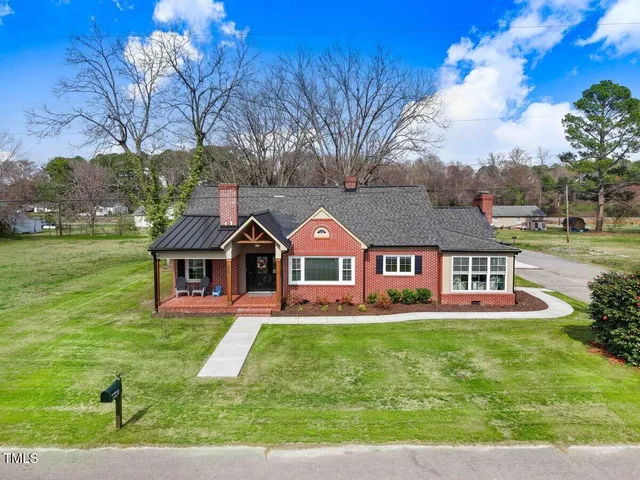 a front view of house with yard and green space