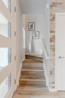 a view of staircase with lots of frames on wall