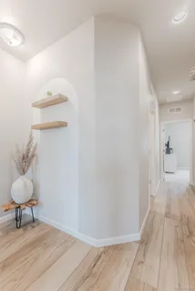 a view of a room with wooden floor and a cabinet