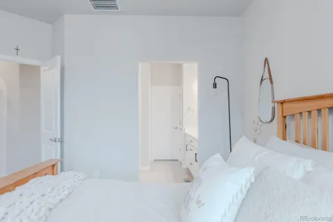 a large white bed in a white room