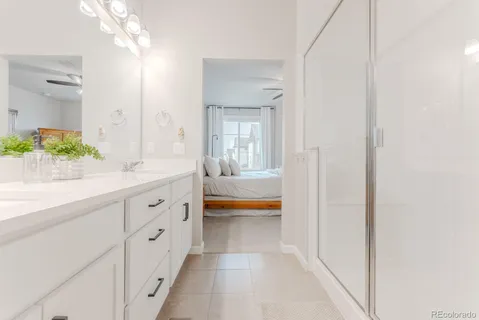 a spacious en suite bathroom with a sink and a bath tub
