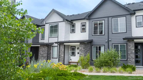 a front view of a house with a yard and porch