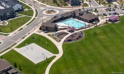 an aerial view of a house with a garden and swimming pool