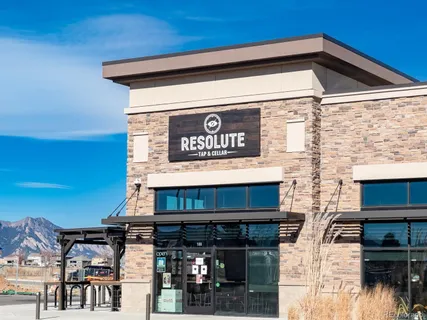 a view of a wooden door and brick wall