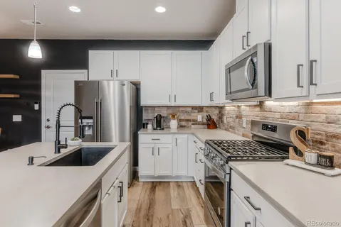 a kitchen with a sink stove and refrigerator