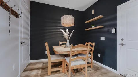 a dining room with a table and chairs