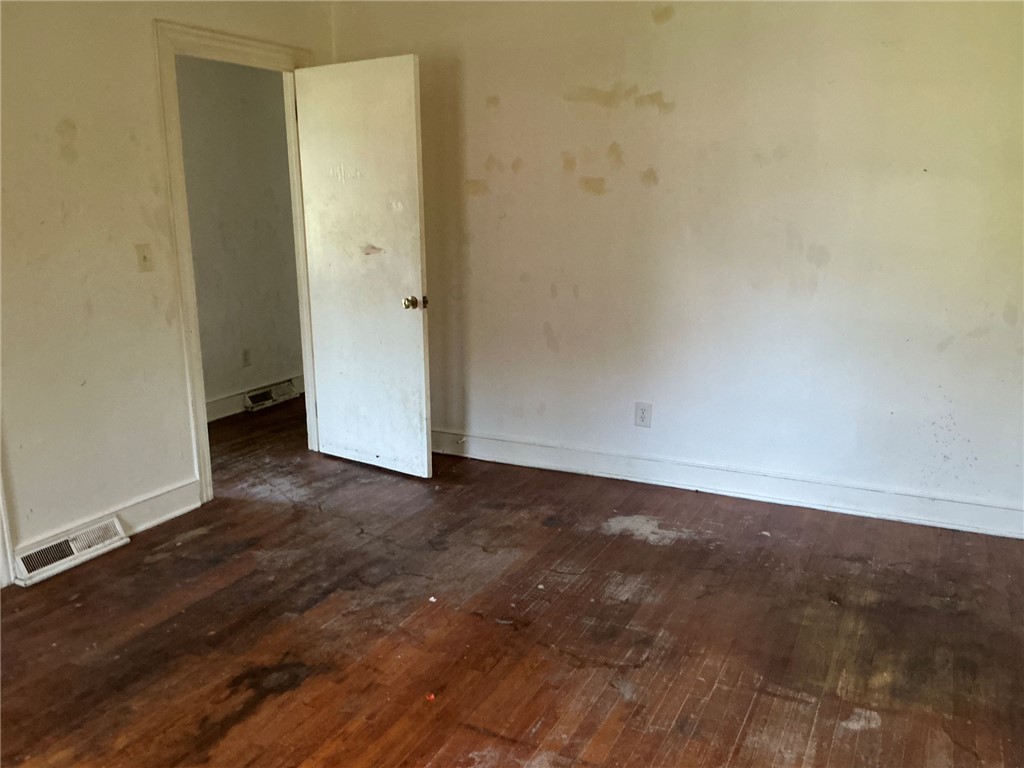 609 West Geer Street Honea Path, SC 29654 - Photo 17 of 18 Hardwood floors and classic trim define this versatile room awaiting personal customization.