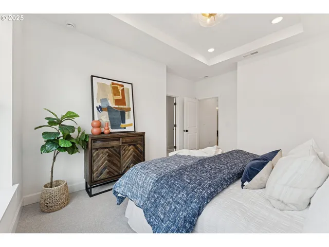 a bedroom with a bed and a potted plant