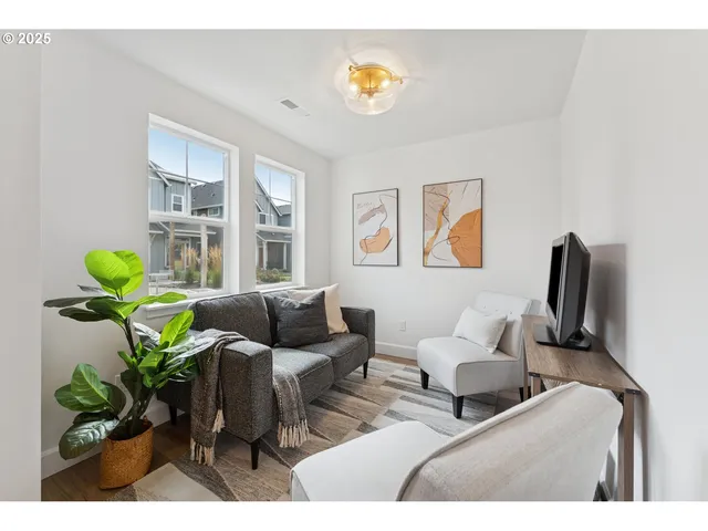 a living room with furniture flowerpot and a window