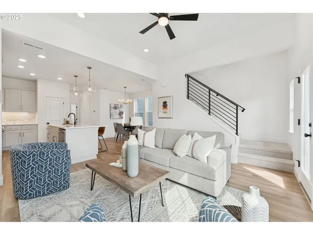 a living room with furniture a rug and white walls