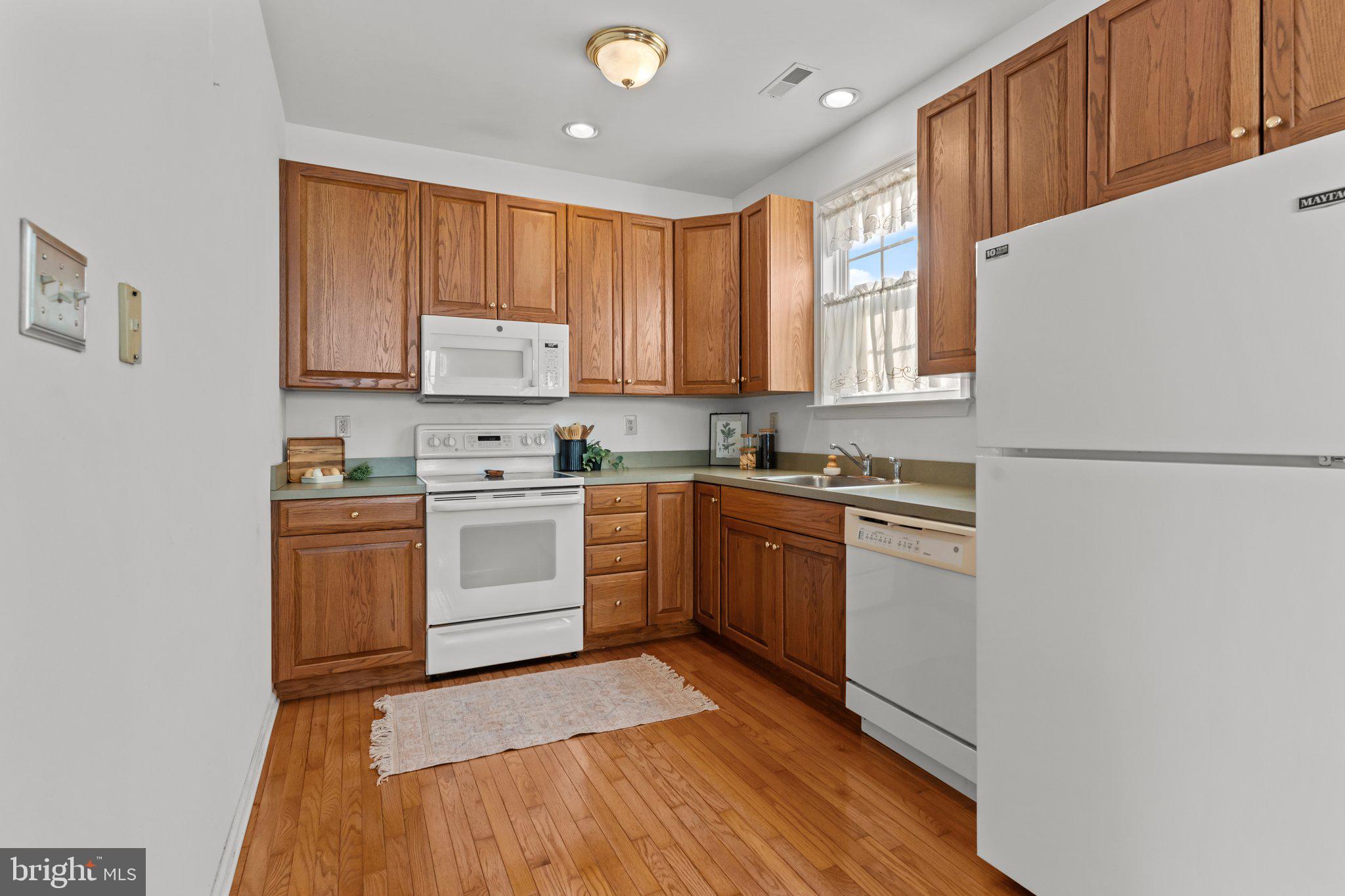 237 Beaumont Drive Oxford, PA 19363 - Photo 11 of 46 a kitchen with a white cabinets and white appliances